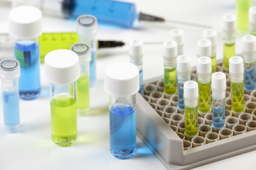 Close up of vials containing blue and green liquid