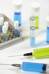 Close up of syringe's containing blue and green liquid