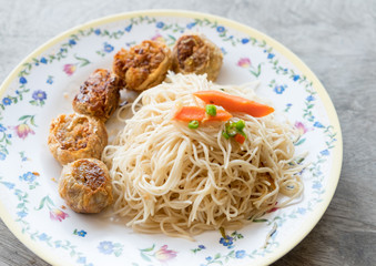 Stir fried white noodle hong kong and Hoi jo Deep fried chicken roll on wood table