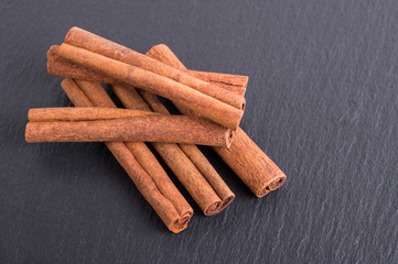 Cinnamon sticks on slate tile with faded effect
