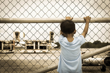 Behind of little boy sad standing alone