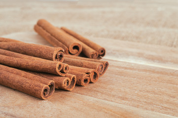 Cinnamon sticks on cutting board with faded effect