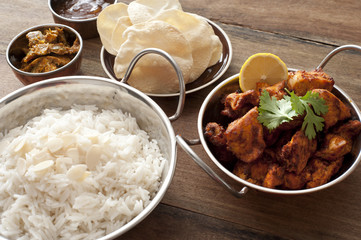 Indian cuisine with bread, rice and spicy chicken