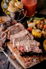 Grilled steak sliced on a cutting board.