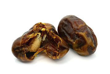 Dry date palm fruit on white