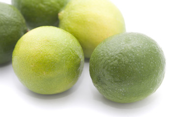 Fresh and green limes on white background