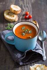 Tomato soup with herbs in a mug