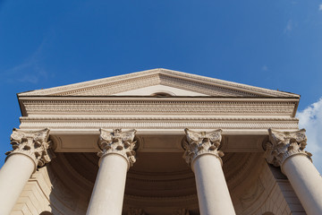 Capitol facade with columns on blue sky background. Bottom view