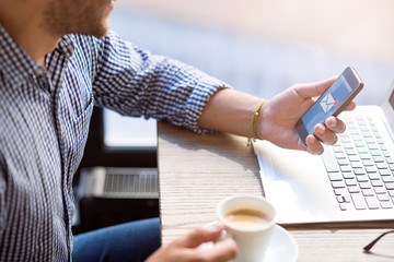 Pleasant bearded man using cell phone