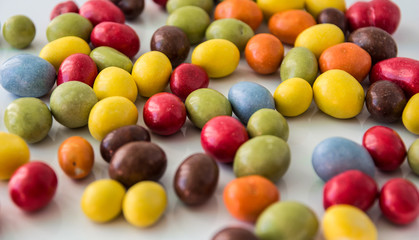 colored chocolate drops on white background