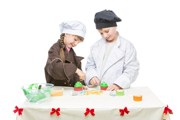 Children making christmas cupcakes
