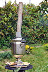 Samovar traditional russian cutlery  teapot in the garden 