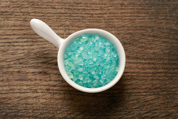 Bowl of blue sea salt on wood