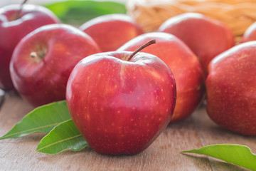 Red apples on wooden table
