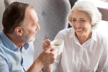 Cheerful delighted couple drinking coffee