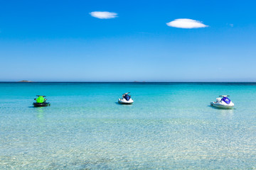 Fototapeta na wymiar Jet ski mooring in the turquoise water of Rondinara beach in Co