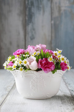 Floral arrangement with pink eustomas, carnations and chamomile