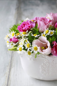 Floral arrangement with pink eustomas, carnations and chamomile