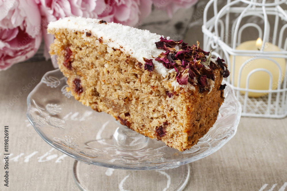 Poster Carrot vegan cake with coconut icing and dried wild rose petals