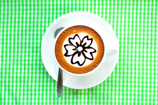 Coffee cup with flower picture on top
