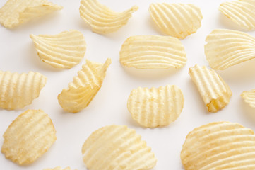 Individual potato chips over white background