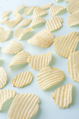 Background of scattered crinkle cut crisps