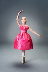 Little young ballerina girl in pink dress doing gymnastic split. © jutaphoto
