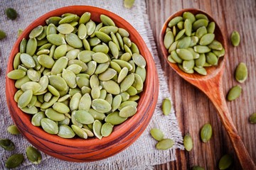 organic pumpkin seeds in a clay bowl