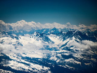 Fototapeta na wymiar Winter landscape of mountains with snow under blue cloudy sky