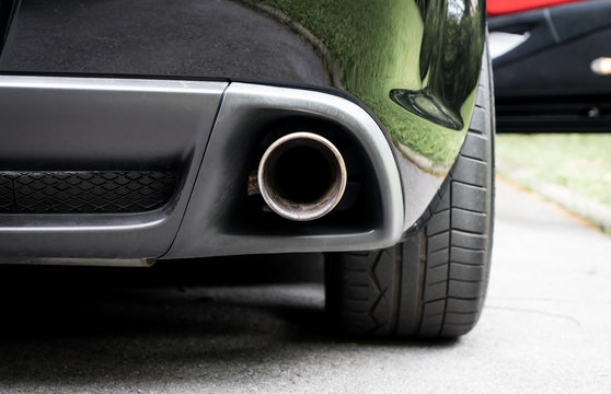 Sport Car muffler in the back of a black luxury sport car.