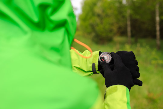 Hiker looking at electronic compass on travel