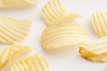 Various scattered ridged potato chips