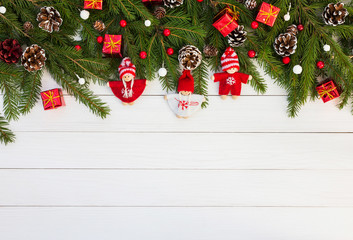 Fototapeta na wymiar Christmas background. Decorated Christmas fir tree branch on white wooden background. Copy space 