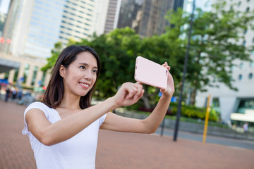 Woman taking photo by mobile phone