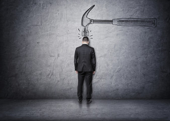 Big hand drawn hammer hitting a businessman on his head