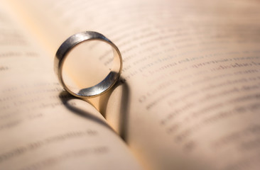 Ring with love shape, hearth shadow in a book - 119834762