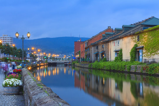 Fototapeta Otaku, Japan historic canal and warehouse in summer twilight time, famous tourist attraction of Sapporo Hokkaido.