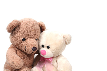Couple teddy bears hugging on white background.