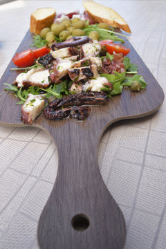 Plate with calamare, olives,tomatoes and Prosciutto, picture from Croatia.