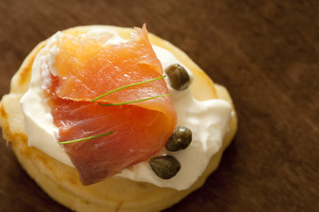 Blini with thin slice of salmon