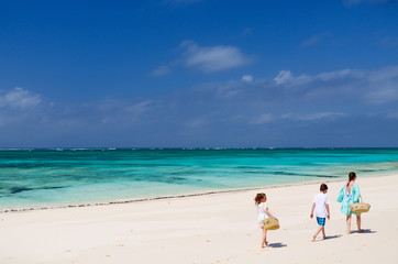 Fototapeta na wymiar Mother and kids at tropical beach