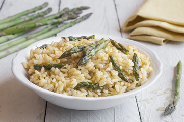 Rice with asparagus on wooden table