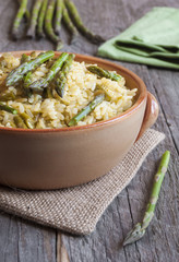 Rice with asparagus on wooden table