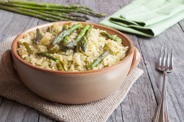 Rice with asparagus on wooden table