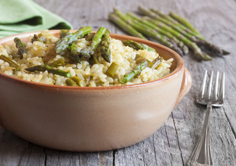 Rice with asparagus on wooden table