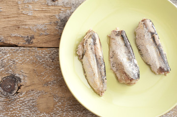 canned sardines on green plate