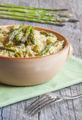 Rice with asparagus on wooden table