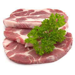 Raw pork neck chop meat with parsley herb leaves garnish isolate