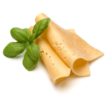 cheese slices and basil herb leaves isolated on white background