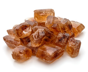 Brown caramelized lump cane sugar cube isolated on white backgro